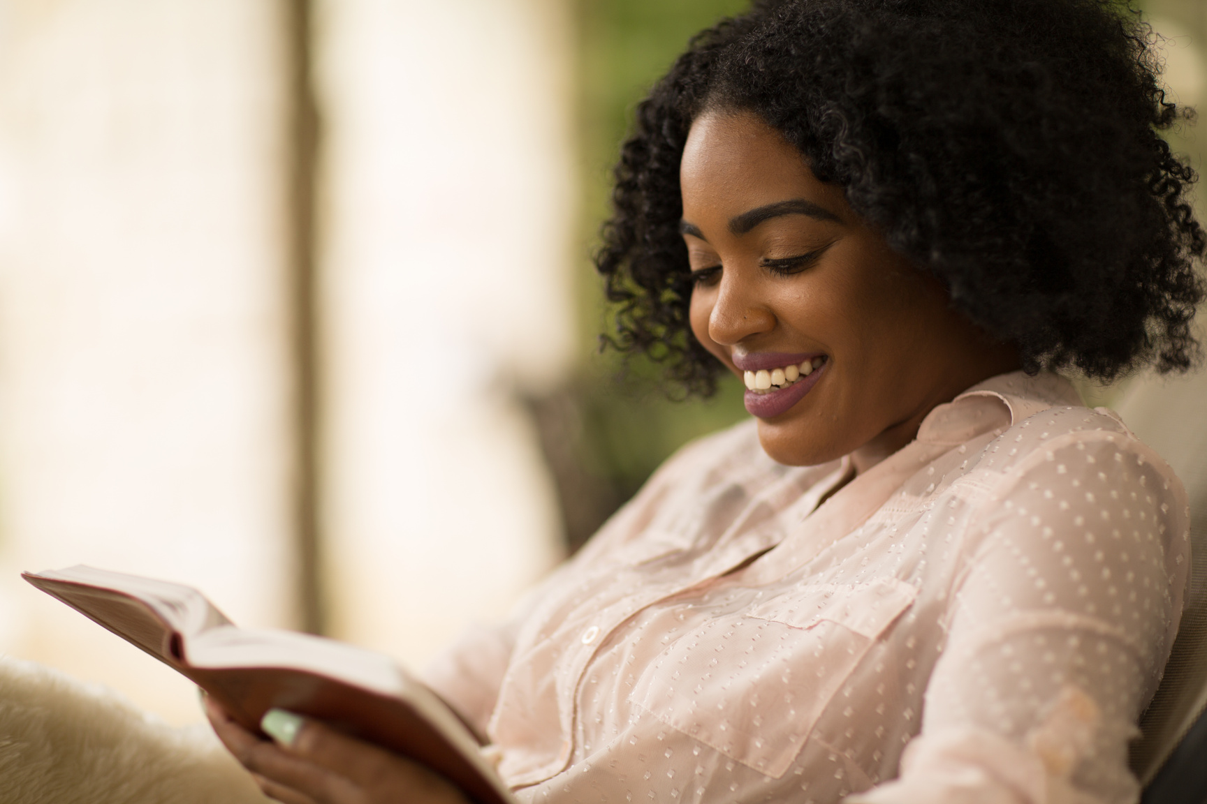 African American Woman Studing and Reading the Bible.